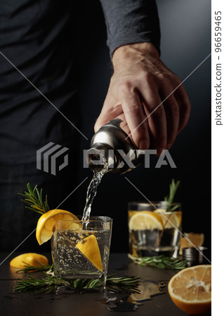 Cocktail Gin-tonic with lemon and rosemary. 96659465