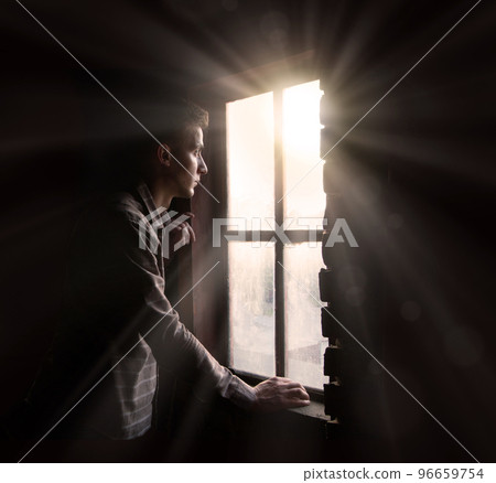 Young guy at the old window 96659754