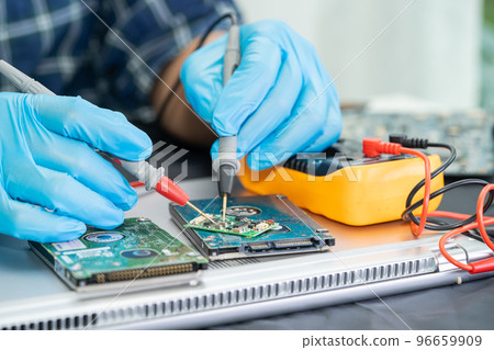 Technician repairing inside of mobile phone by soldering iron. Integrated Circuit. the concept of data, hardware, technology. 96659909