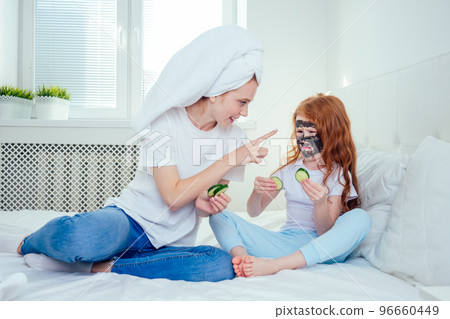 redhaired ginger woman and foxy little girl make cucumbers clay mask redhaired ginger woman and foxy little girl make cucumbers clay mask 96660449