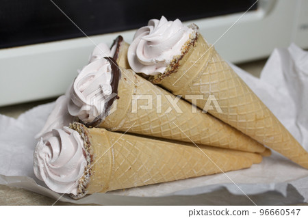Homemade marshmallows in waffle cones. Homemade zephyr. 96660547