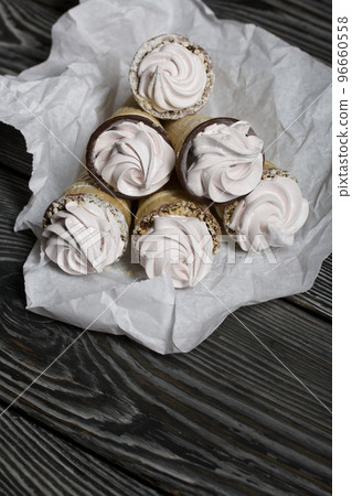 Homemade marshmallows in waffle cones. Homemade zephyr. 96660558