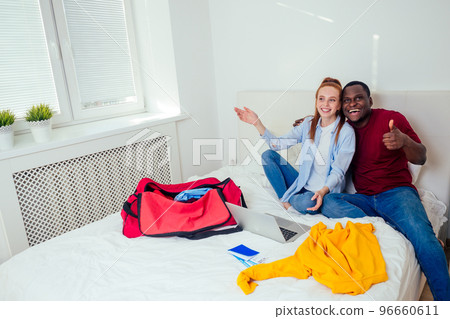 latin hispanic man and redhaired ginger woman unpacking in new house apartment latin hispanic man and redhaired ginger woman unpacking in new house apartment 96660611