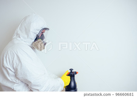 pest control worker spraying pesticides with sprayer in apartment copy spase white walls background 96660681