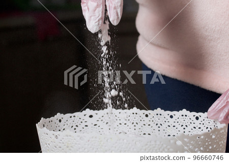 A woman mixes dextrose with powdered sugar. For processing marshmallows. Homemade zephyr. A woman mixes dextrose with powdered sugar. For processing marshmallows. Homemade zephyr. 96660746
