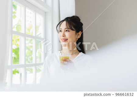 A woman drinking vegetable juice A woman drinking vegetable juice 96661632