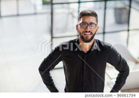 Portrait of smiling young businessman in office 96661784