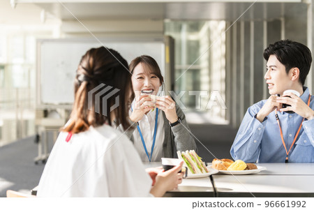 Young men and women having lunch happily 96661992