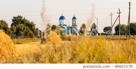 Old wooden orthodox church of the nativity of the Most Holy Theotokos in sunny summer evening. Countryside landscape. Architectural monument. Glybotskoye, Gomel Region, Belarus. Panorama, panoramic 96663576