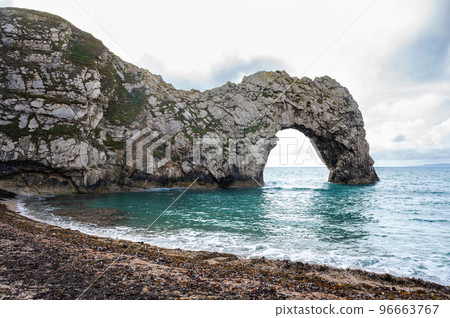 Views of natural rock formations Durdle door in Lulworth, Dorset, United Kingdom. Part of Jurassic Coast World Heritage Site, view of stone arch and blue sea, selective focus Views of natural rock formations Durdle door in Lulworth, Dorset, United Kingdom. Part of Jurassic Coast World Heritage Site, view of stone arch and blue sea, selective focus 96663767
