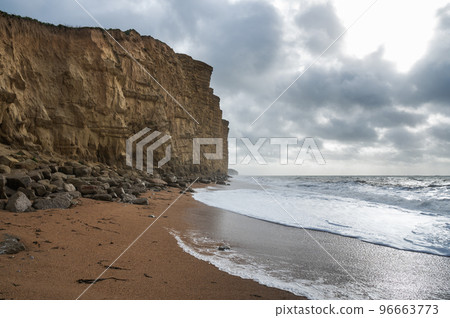 Rock formations, sandstone cliffs in West Bay beach, located near Bridport in Dorset, United Kingdom. Part of famous Jurassic coast, World Heritage Site, selective focus 96663773