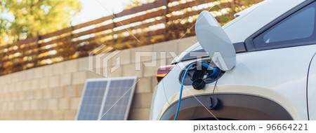 Charging electric car from home photovoltaics power station ,sustainable and economic transportation concept. Charging electric car from home photovoltaics power station ,sustainable and economic transportation concept. 96664221