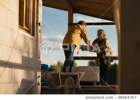 Mature man working on construction site of their new house. Mature man working on construction site of their new house. 96664367