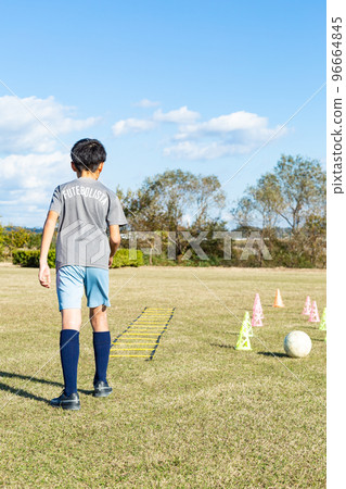Boy practicing soccer Boy practicing soccer 96664845