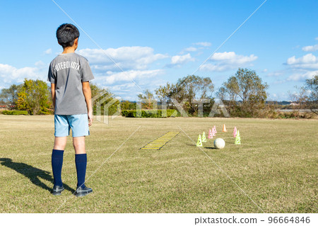 Boy practicing soccer Boy practicing soccer 96664846