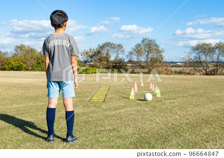Boy practicing soccer Boy practicing soccer 96664847