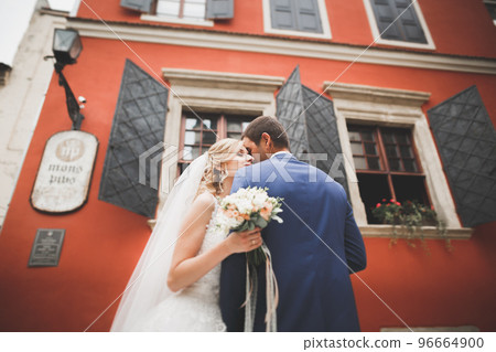 Gorgeous wedding couple walking in the old city of Lviv 96664900