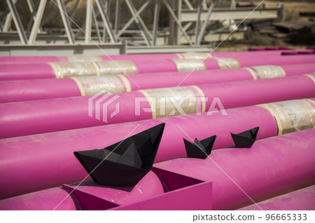 black paper ships sail through pink iron pipes. imitation 96665333