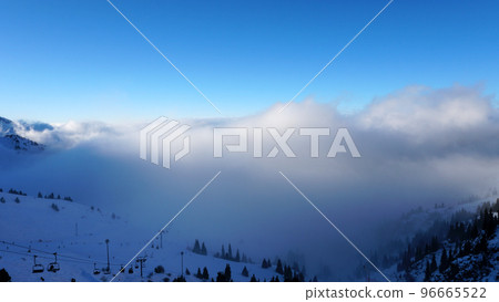 An epic ocean of clouds and fog in the mountains 96665522