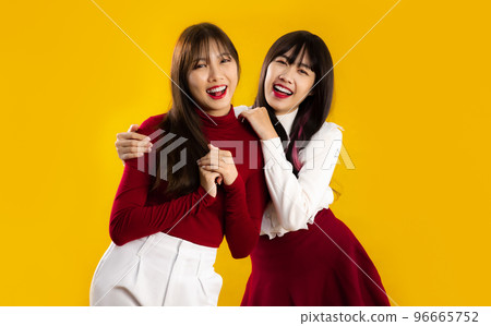 Young asian woman in red and white color Christmas theme costume wearing santa hat surprised when open shopping bag Young asian woman in red and white color Christmas theme costume wearing santa hat surprised when open shopping bag 96665752