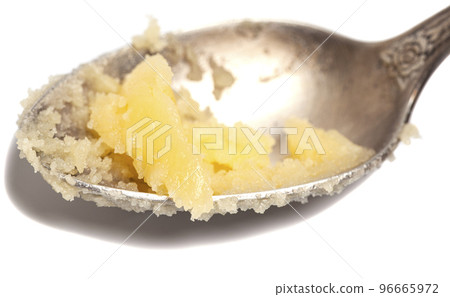 Ghee in spoon isolated on white background. Ghee in spoon isolated on white background. 96665972