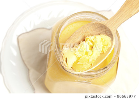 Ghee in jar and wooden spoon isolated on white background 96665977