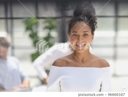 a business woman smiling inside office building 96666387