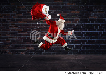 santa claus runs fast to deliver all gifts for christmas 96667375