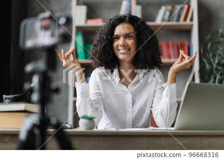 Woman freelancer recording video blog how to relieving stress by meditation at workplace Woman freelancer recording video blog how to relieving stress by meditation at workplace 96668316