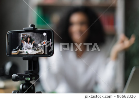 Focus on modern smartphone fixed on tripod. 96668320