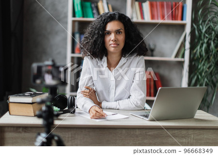Female blogger sitting at home and doing live stream. 96668349