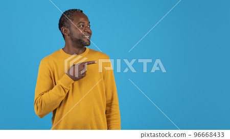 Happy african american middle aged man pointing at copy space Happy african american middle aged man pointing at copy space 96668433