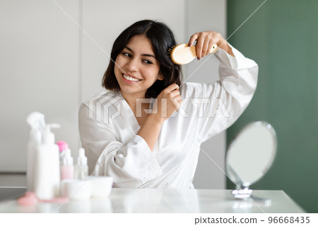 Pretty Woman Combing Her Beautiful Hair With Brush At Home 96668435