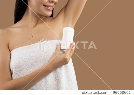 Cropped of half-naked lady with arm up using deodorant 96668601