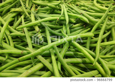 Stack of green beans on a market stall Stack of green beans on a market stall 96668799