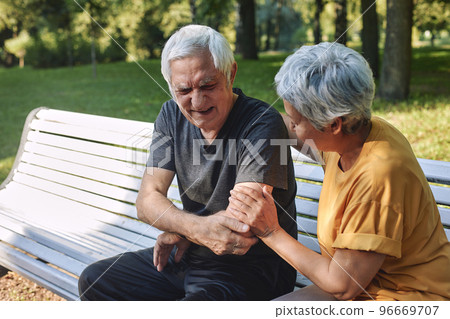 Older man got injured shoulder during stroll with wife Older man got injured shoulder during stroll with wife 96669707