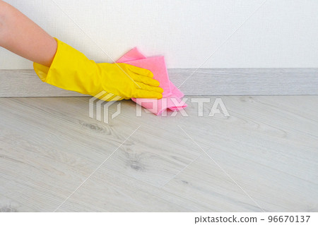 Cleaning floor in room close up. Woman cleaning parquet floor with rag at home. Housework and housekeeping concept. Cleaning floor in room close up. Woman cleaning parquet floor with rag at home. Housework and housekeeping concept. 96670137