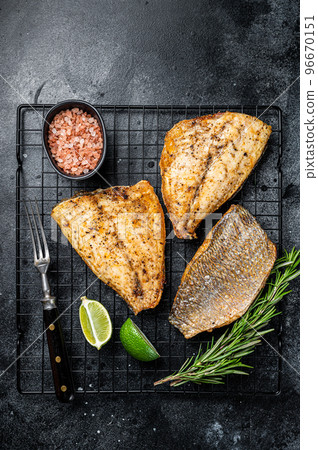 Baked Dorado Sea Bream fillets. Black background. Top view Baked Dorado Sea Bream fillets. Black background. Top view 96670151