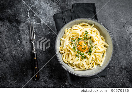 Traditional Bavarian Spaetzle egg Noodles with Butter and Parsley. Black background. Top view Traditional Bavarian Spaetzle egg Noodles with Butter and Parsley. Black background. Top view 96670186