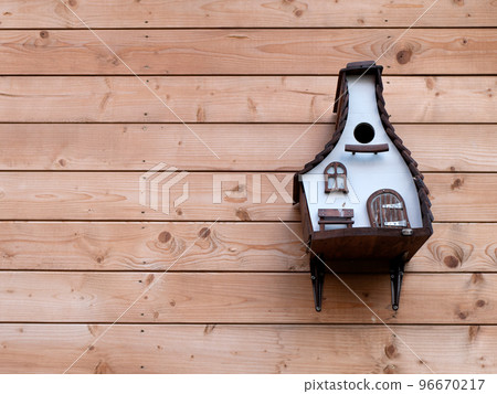 Birdhouse or roost box on the wooden wall of a building, selective focus. Care for animals 96670217