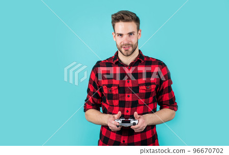 bearded man with bristle play video game with remote. fashion and beauty. barbershop concept. computer game. young handsome guy in checkered shirt. stylish male wear casual clothes 96670702