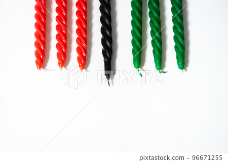 Happy Kwanzaa concept. Afro-American holiday. Seven candles - red, black and green. African heritage symbol on white background. Happy Kwanzaa concept. Afro-American holiday. Seven candles - red, black and green. African heritage symbol on white background. 96671255