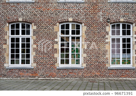 Ternat, Flemish Brabant Region, Belgium, Traditional brick stone wall with symmetrical windows of a school Ternat, Flemish Brabant Region, Belgium, Traditional brick stone wall with symmetrical windows of a school 96671391