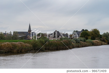Berlare, East Flemish Region, Belgium - View over the River Scheldt, the banks and the village in the background 96671409