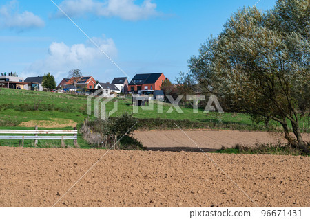 Asse ter Heide, Flemish Brabant  - Harvested farmland and residential houses at the Flemish countryside 96671431