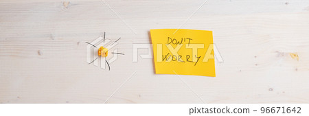 Wide view image of a yellow paper with Dont worry sign on it placed on wooden background Wide view image of a yellow paper with Dont worry sign on it placed on wooden background 96671642