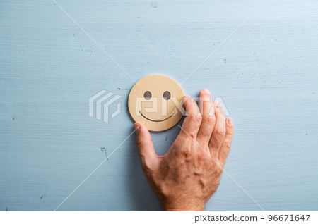 Smiling face cut into a wooden cut circle Smiling face cut into a wooden cut circle 96671647