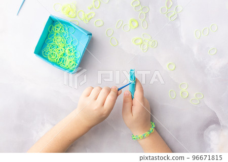 Concept of making loom bracelets by kids blue and yellow Concept of making loom bracelets by kids blue and yellow 96671815
