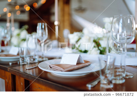 Beautiful table setting for a party, wedding reception or other festive event. Banquet setting, glasses, plates. Beautiful table setting for a party, wedding reception or other festive event. Banquet setting, glasses, plates. 96671872