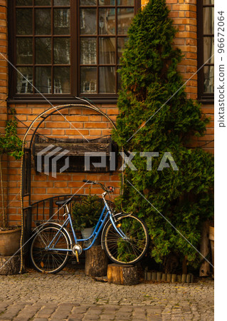 Bicycle parked as decoration in Ancient architecture of old town in Gdansk Poland. Beautiful and colorful old houses historical part of downtown. Travel destination Bicycle parked as decoration in Ancient architecture of old town in Gdansk Poland. Beautiful and colorful old houses historical part of downtown. Travel destination 96672064